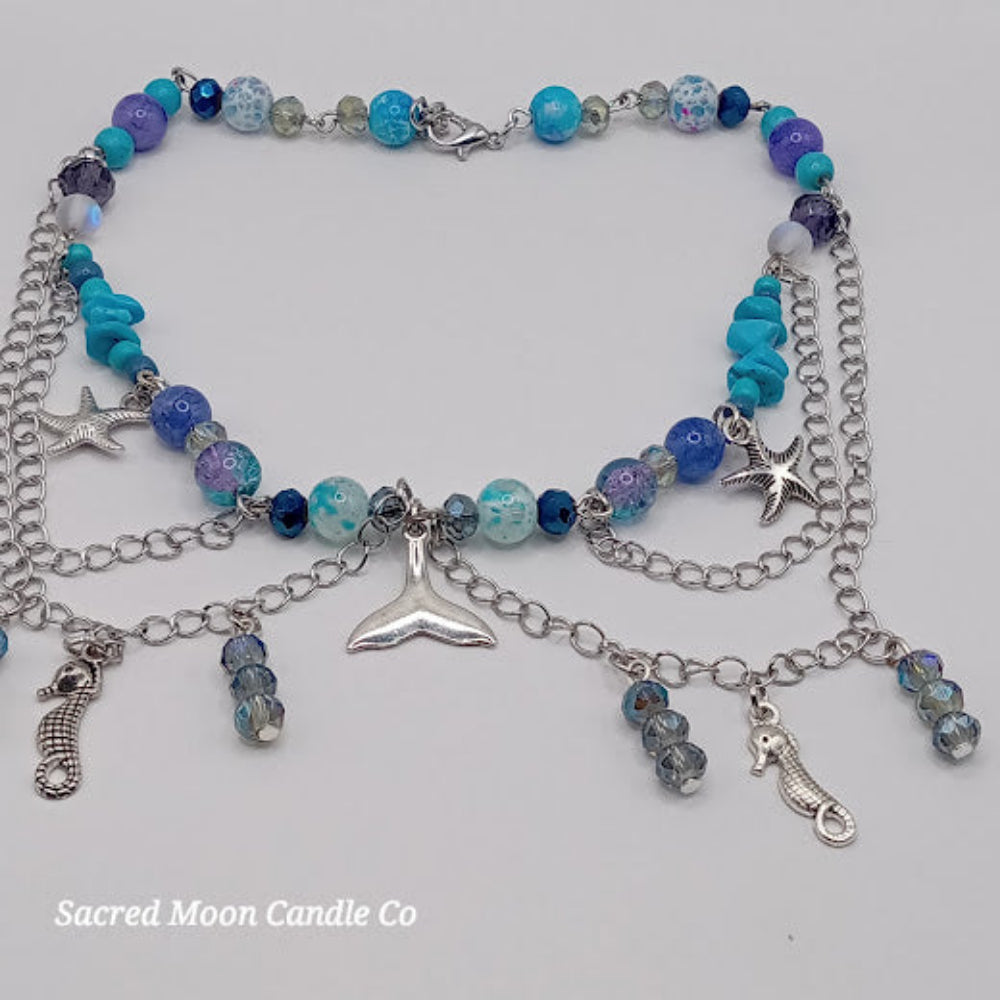 Mermaid tail choker necklace with blue beads, silver chains, starfish and seahorse charms