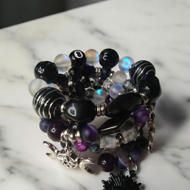 Sacred Moon Candle Co spiritual protection beaded bracelets stack with black and purple beads on marble