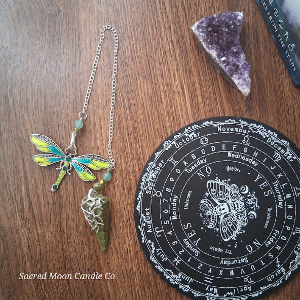 Unakite amazonite dragonfly pendulum with green stone and chain from Sacred Moon Candle Co on wooden surface
