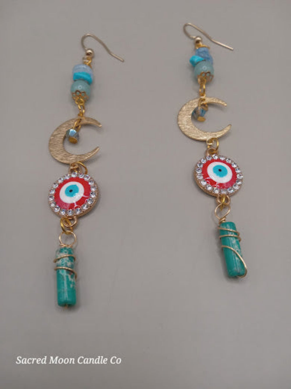 Sacred Moon Candle Co wire wrapped evil eye earrings with turquoise stones and gold crescent charms