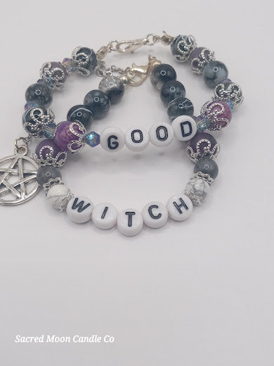Sacred Moon Candle Co witch bracelet stack with white letter beads spelling good witch and decorative silver and purple beads