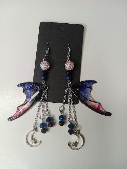 Sacred Moon Candle Co blue magenta bat wing earrings with dangling beads and crescent moon charms