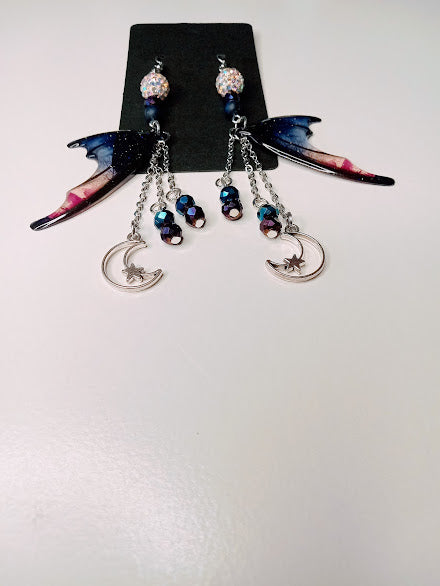 Sacred Moon Candle Co blue magenta bat wing earrings with crescent moon charms and dangling beads