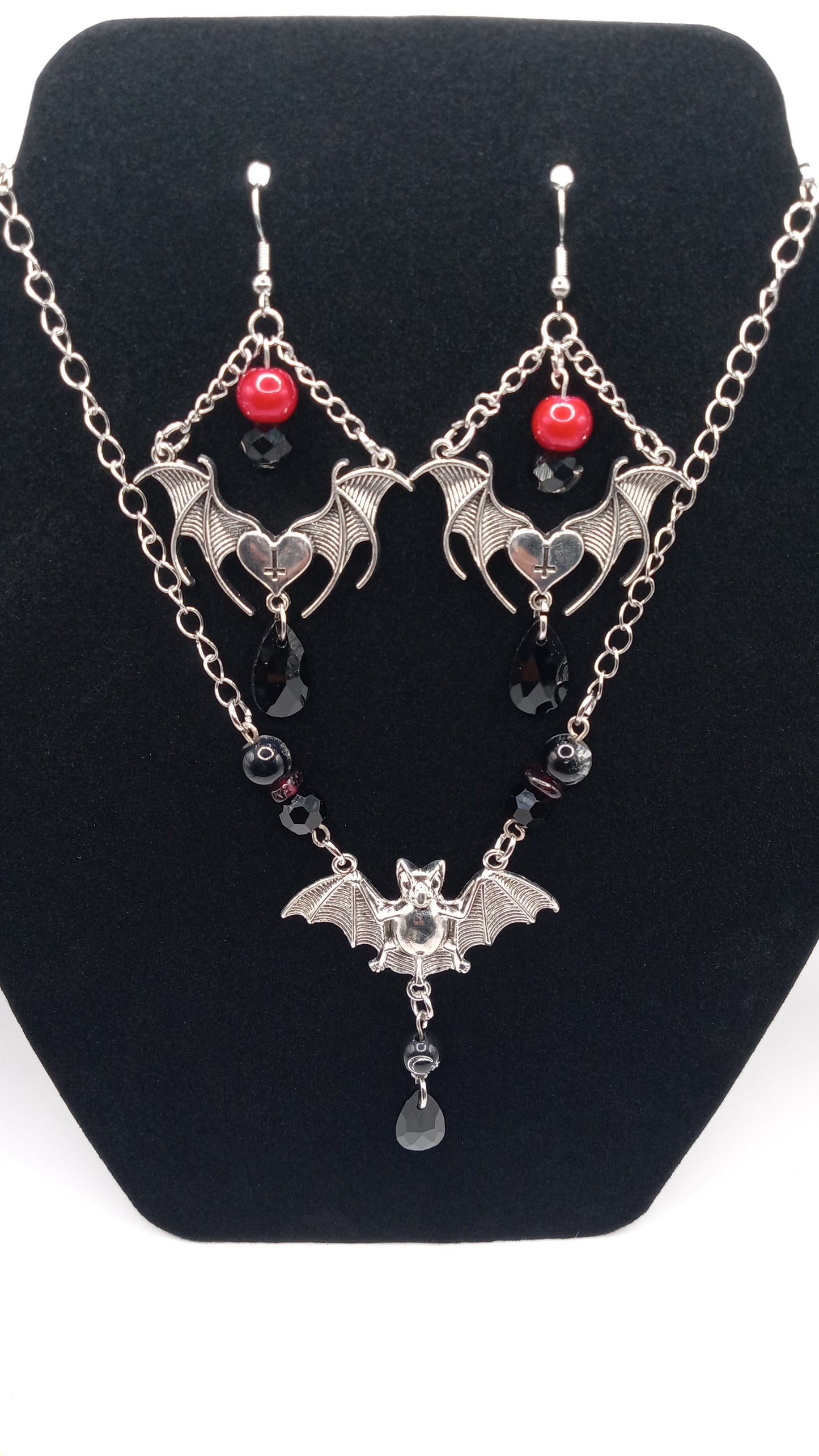 Sacred Moon Candle Co gothic bat jewelry set featuring silver bat earrings with red and black beads and matching necklace