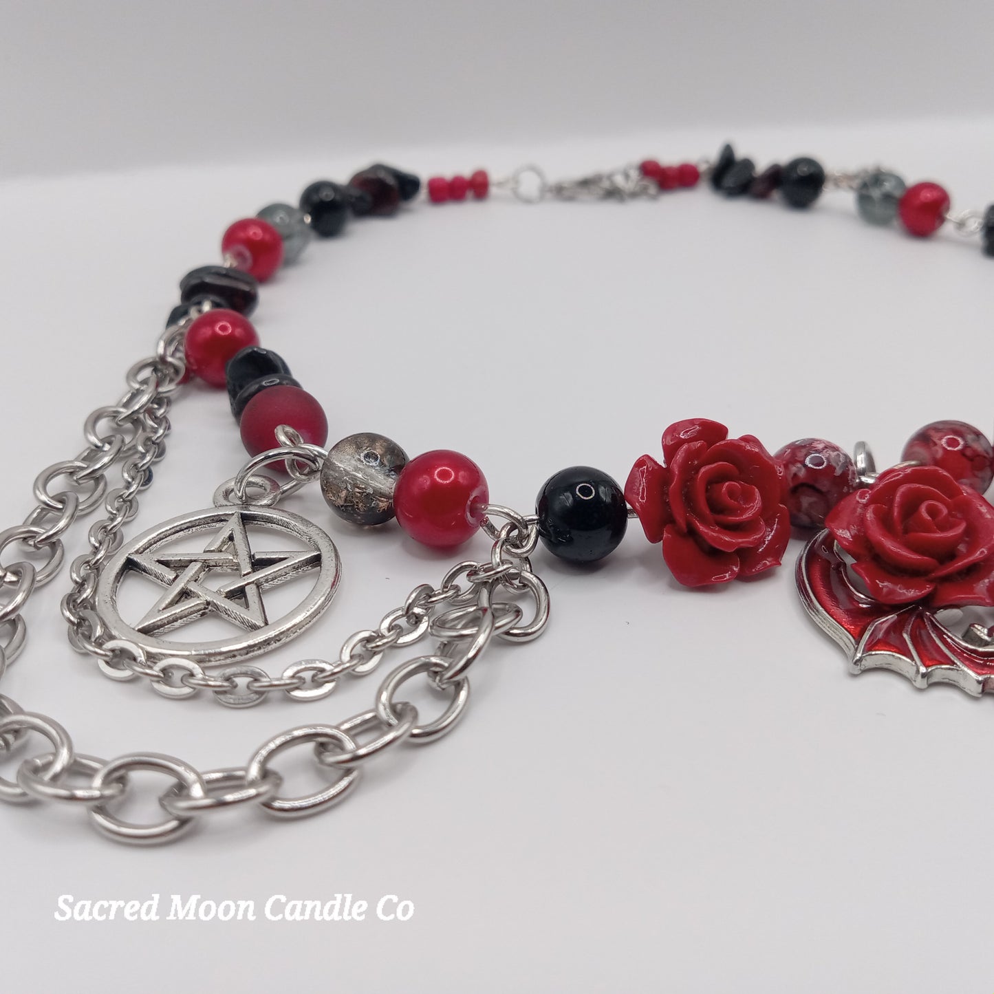 Handmade rose bat choker with red rose charms, black and red beads, and silver pentagram chain