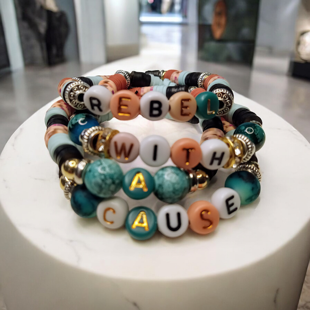 Rebel With A Cause bracelet stack featuring colorful beads and gold accents by Sacred Moon Candle Co