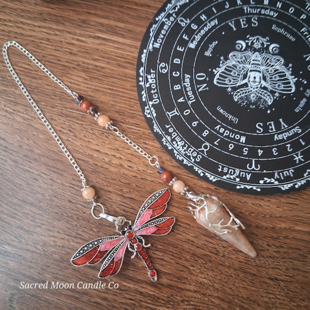 Sunstone dragonfly pendulum for divination with red and orange beads and silver chain from Sacred Moon Candle Co