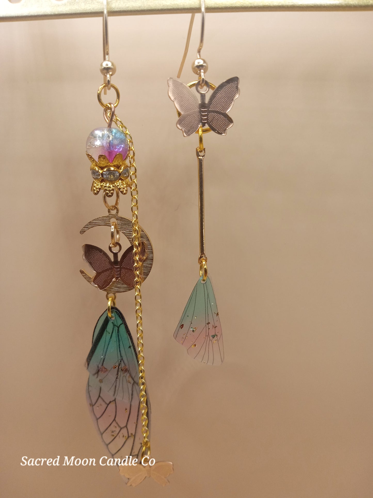 Sacred Moon Candle Co fairy wing earrings with butterfly charms and delicate gradient wings