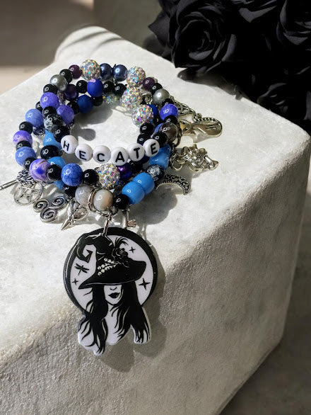 Hecate charm bracelet by Sacred Moon Candle Co with black, blue beads and witch pendant