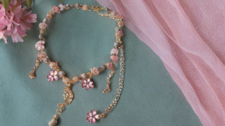 Delicate sakura blossom moon choker with pink flower charms and gold accents by Sacred Moon Candle Co