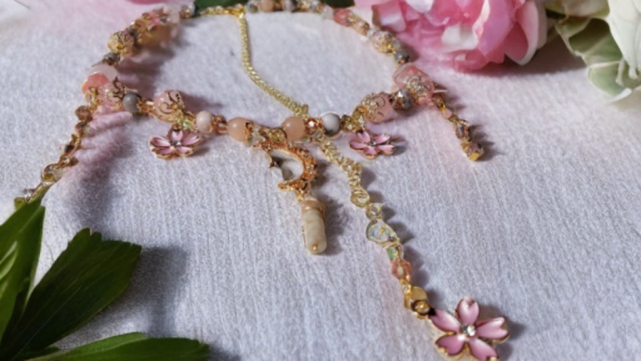 Sacred Moon Candle Co sakura blossom moon choker with pink flowers and gold chain on white background
