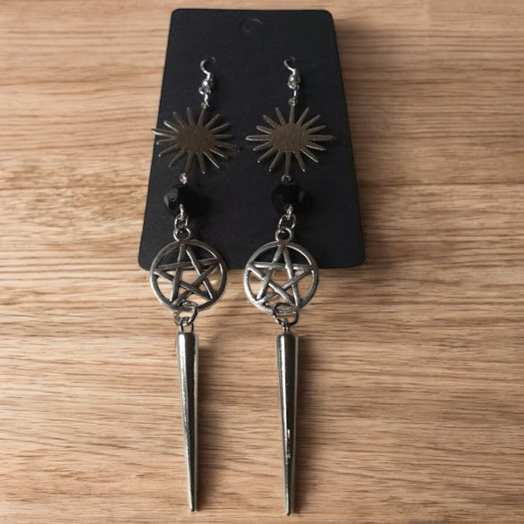 Sacred Moon Candle Co sunburst pentacle earrings with metal sunburst, pentacle charm, and spike dangle