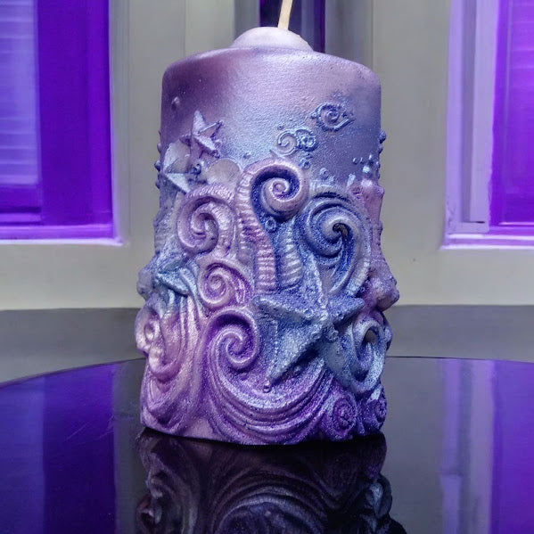 Sacred Moon Candle Co water lily jasmine scented candle with intricate starfish and wave design in purple tones