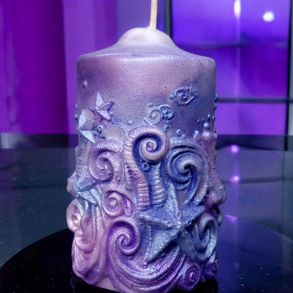 Purple ornate water lily jasmine scented candle by Sacred Moon Candle Co with starfish and swirl designs