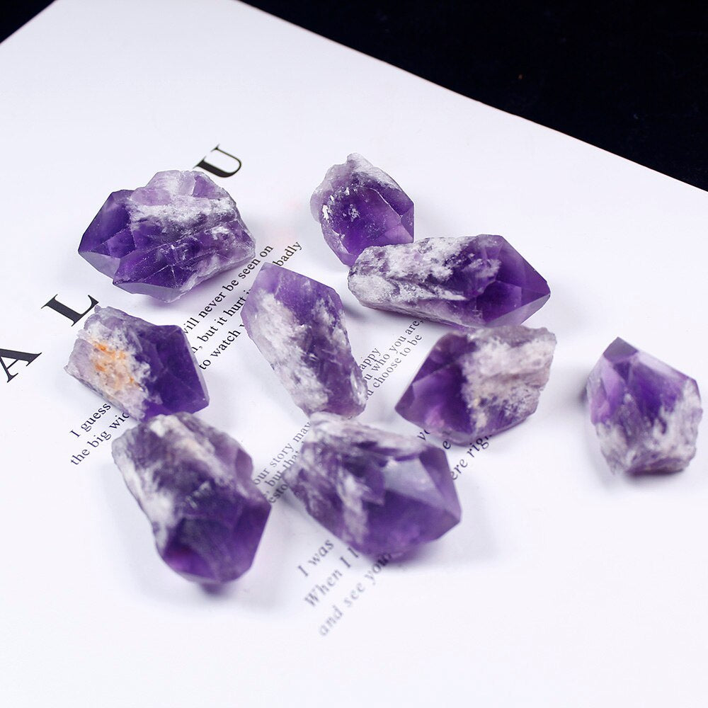 Sacred Moon Candle Co amethyst crystal points natural arranged on a white surface with text
