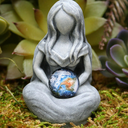 Sacred Moon Candle Co earth goddess Figurine statue in gray holding a glass Earth globe on moss with succulents
