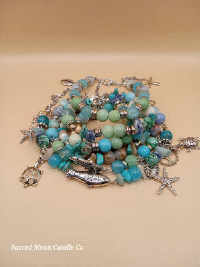 Bohemian beach crystal bracelet stack with silver sea-themed charms by Sacred Moon Candle Co