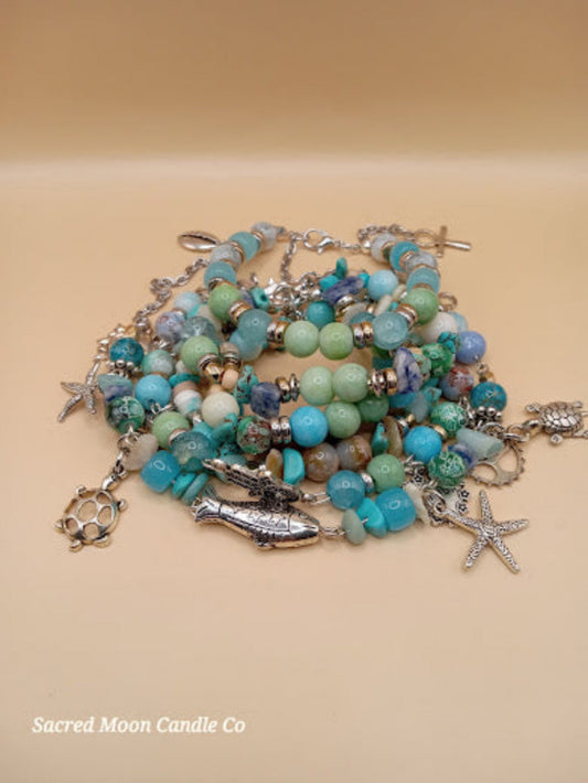 Bohemian beach crystal bracelet stack with silver sea-themed charms by Sacred Moon Candle Co