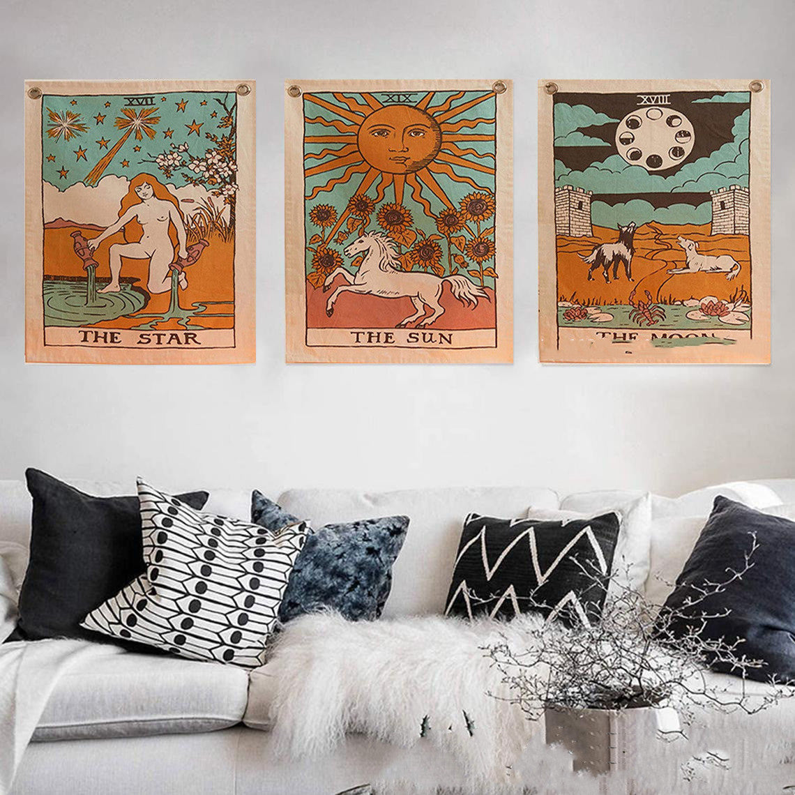 Boho tarot wall decor trio above sofa featuring the sun, moon, and star tapestries . vintage celestial art