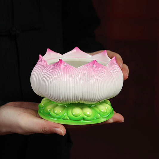 Sacred Moon Candle Co ceramic lotus incense burner with pink petals and green base held in hands