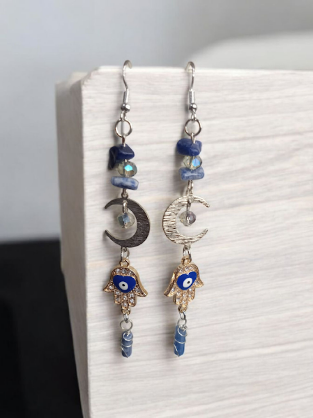 Sacred Moon Candle Co crescent moon hamsa earrings with blue stones and silver hooks