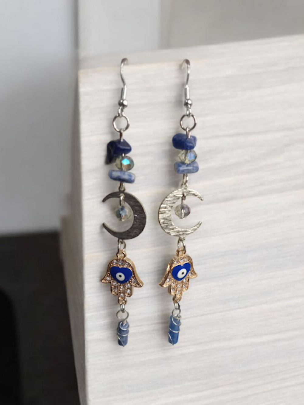 Sacred Moon Candle Co crescent moon hamsa earrings with blue stones and gold hand charms