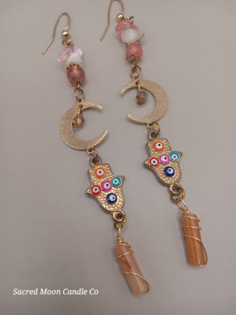 Sacred Moon Candle Co crescent moon hamsa earrings wire wrapped peach aventurine with colorful beads and gold accents