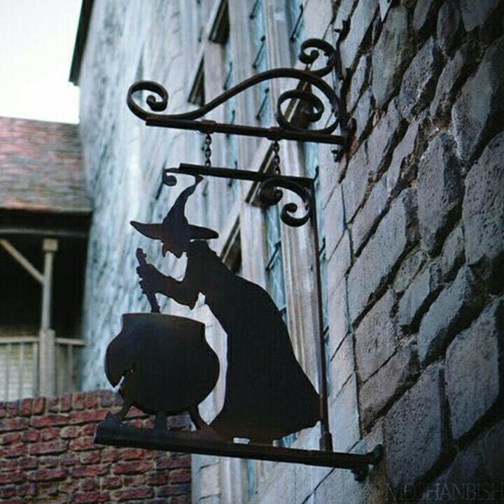 Sacred Moon Candle Co witch cauldron metal wall art silhouette hanging on stone wall