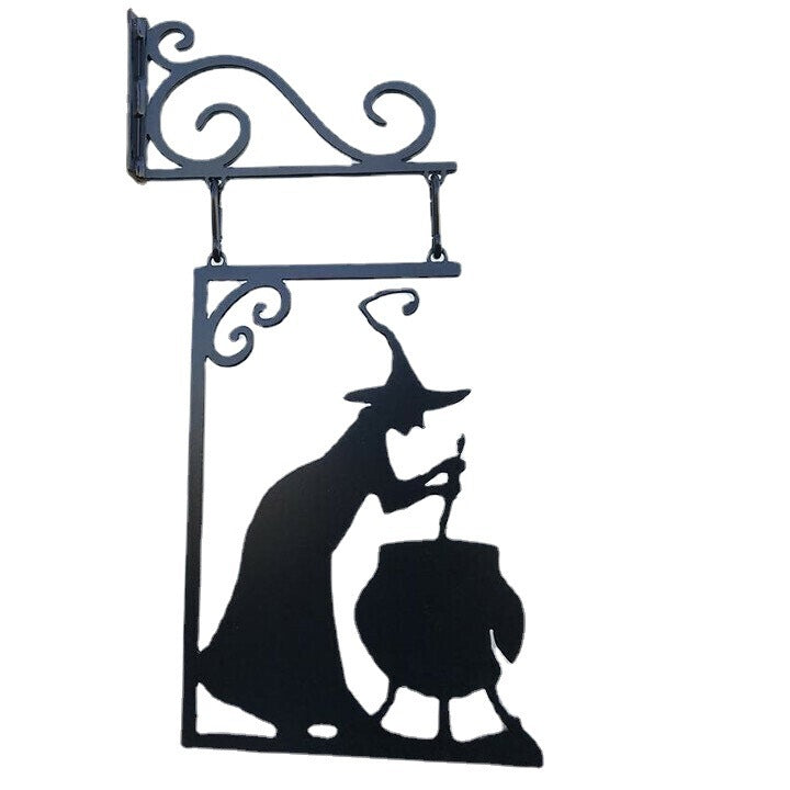 Sacred Moon Candle Co witch cauldron metal wall art featuring a witch stirring a cauldron in black silhouette