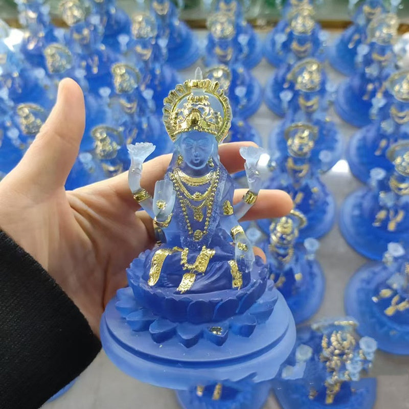 Handheld blue Lakshmi resin altar statue with gold accents seated on lotus for home altar decor