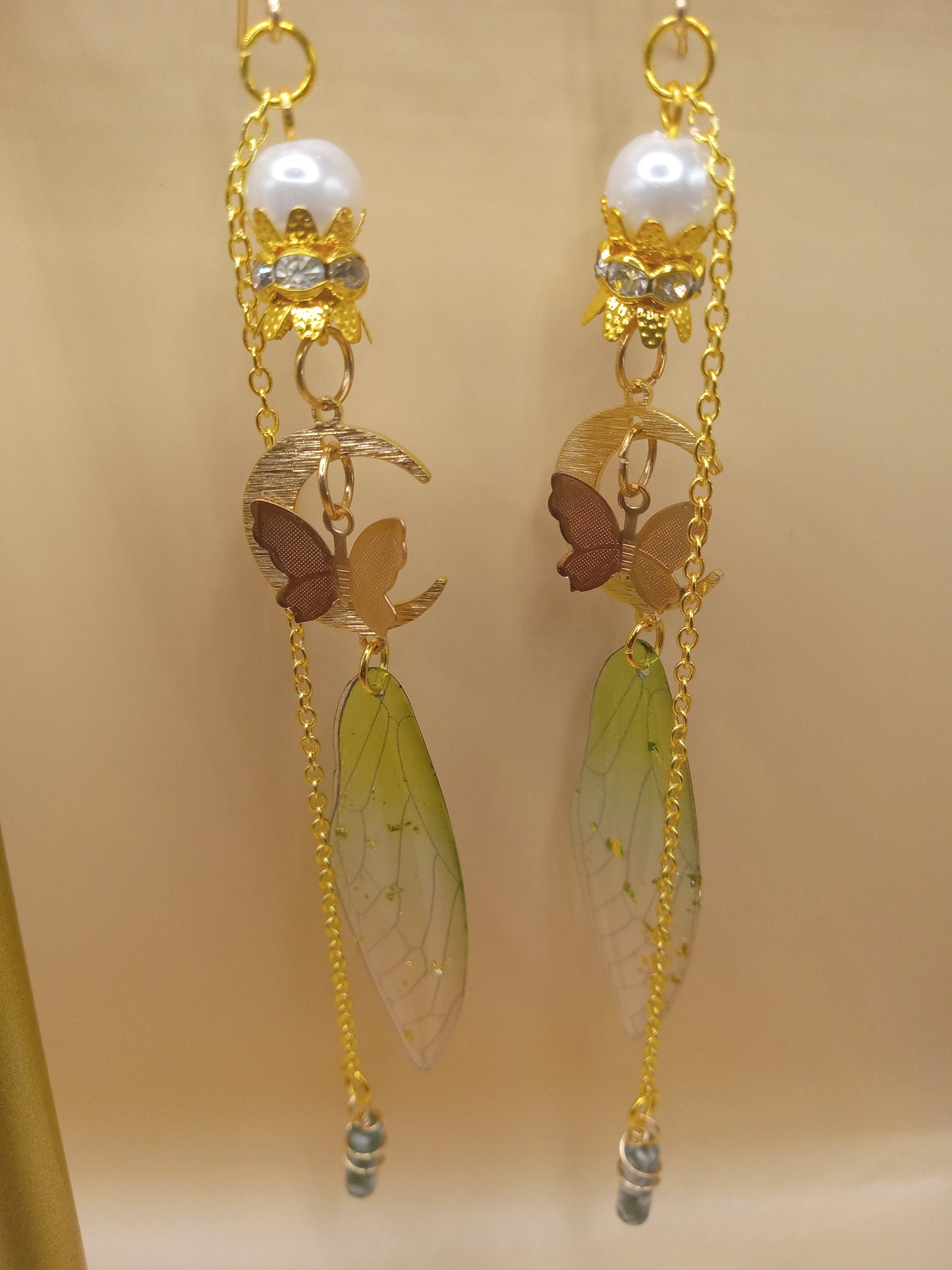 Sacred Moon Candle Co green fairy wing dangle earrings with gold chain pearl top butterfly and moon charms