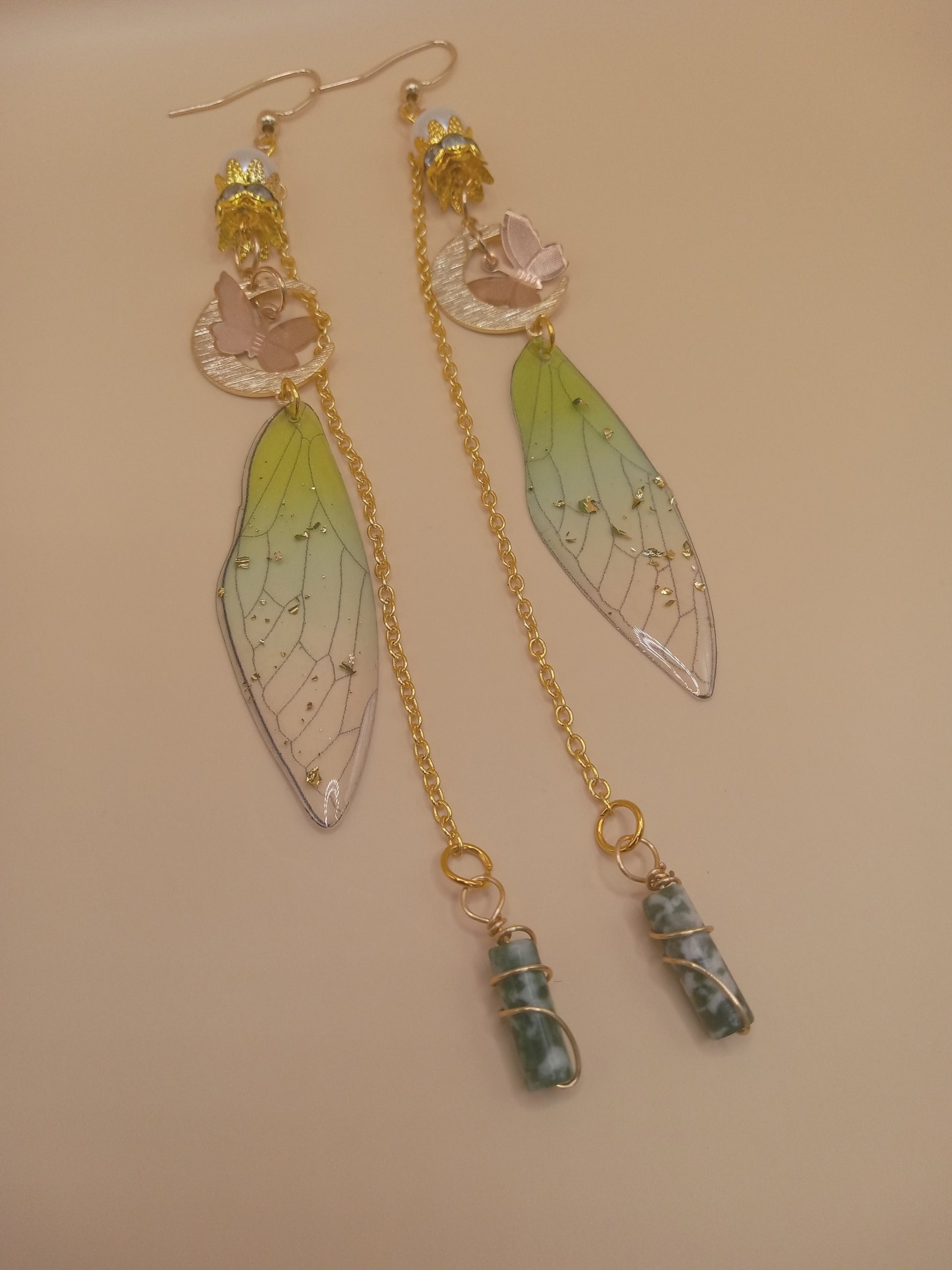 Sacred Moon Candle Co green fairy wing dangle earrings with gold chains crescent moon and wrapped green stone charms