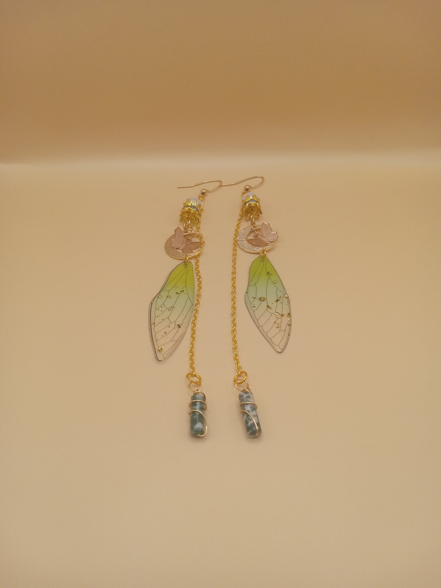 Sacred Moon Candle Co green fairy wing dangle earrings with gold chain pink flower charm and dangling blue stone bead