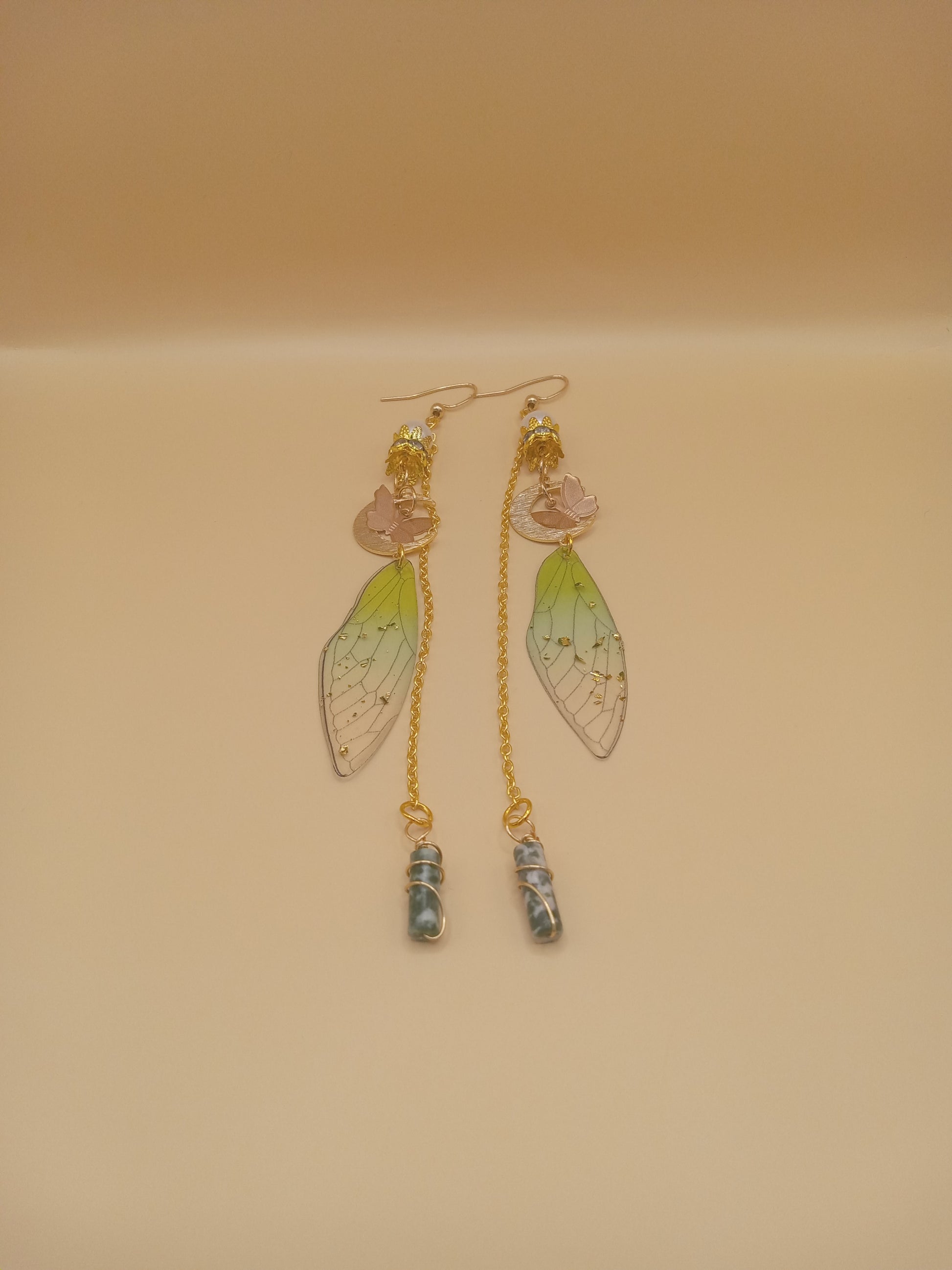 Sacred Moon Candle Co green fairy wing dangle earrings with pink flower accents gold chains and wrapped blue green stone drops