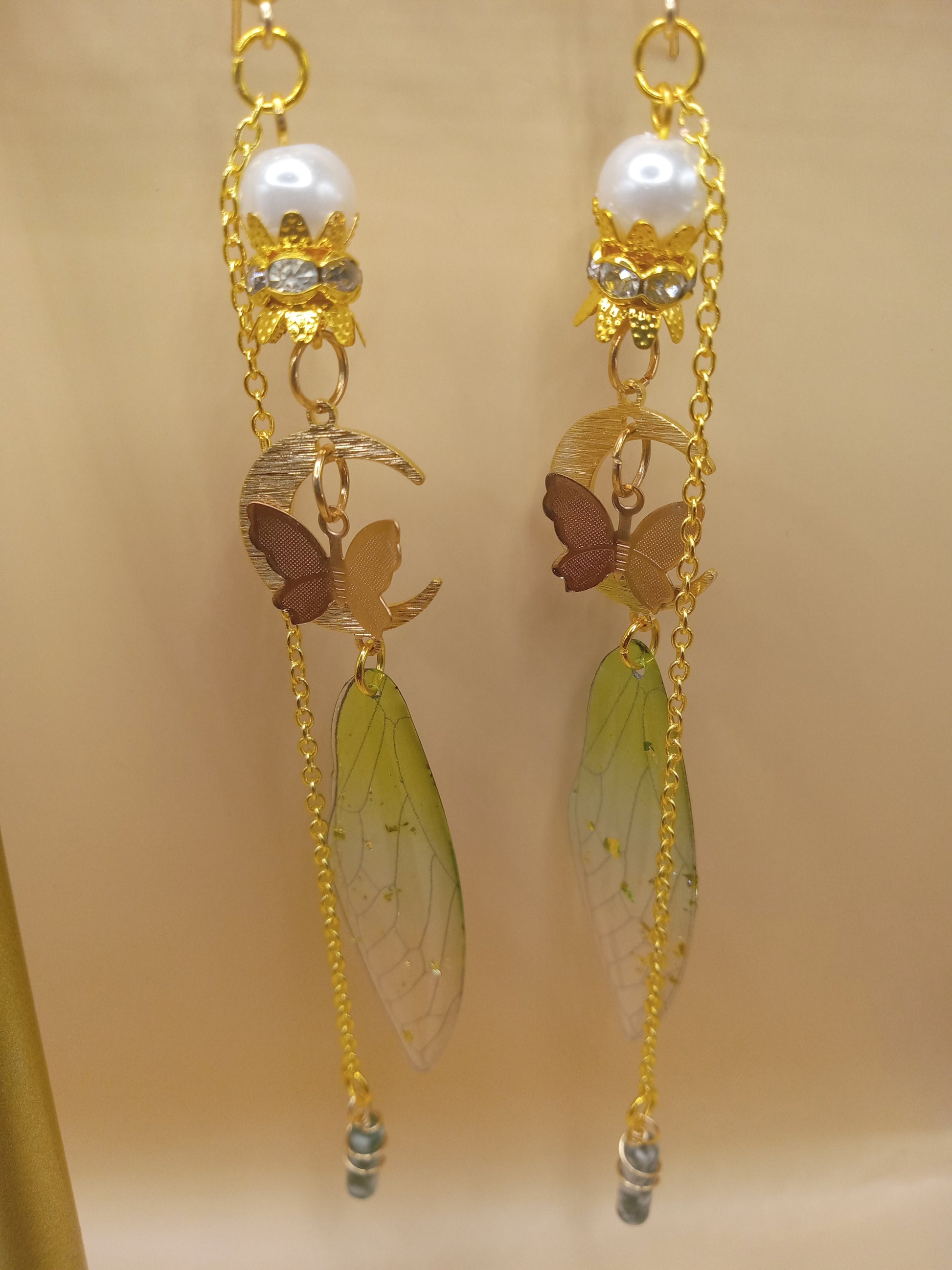 Sacred Moon Candle Co green fairy wing dangle earrings with translucent wings gold chains pearl tops moon and butterfly charms