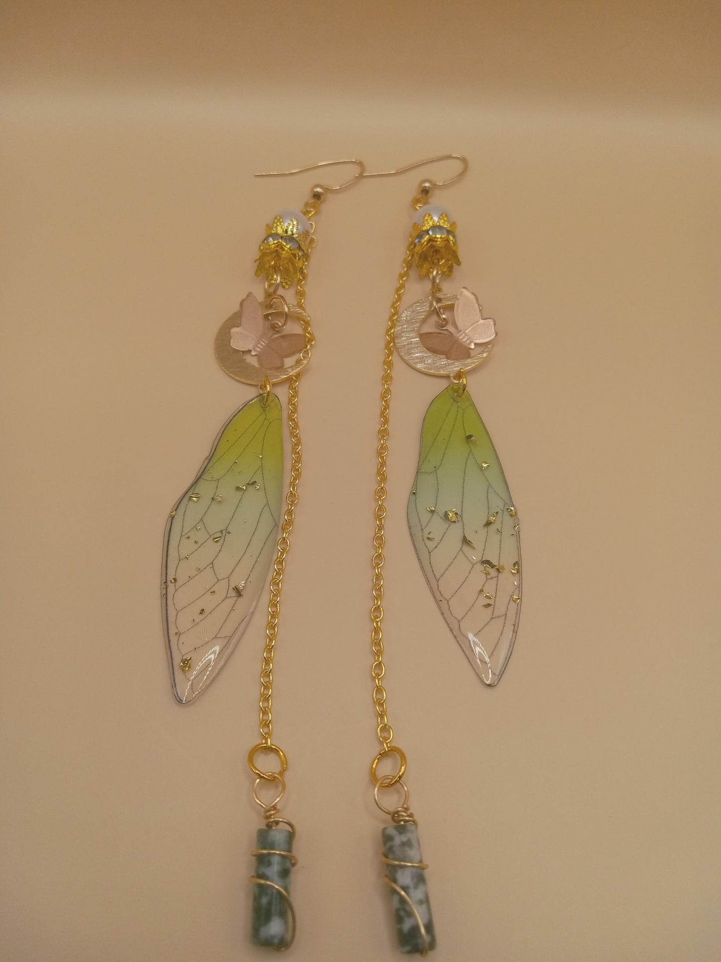 Sacred Moon Candle Co green fairy wing dangle earrings with gold chains bird charm and wrapped green stone