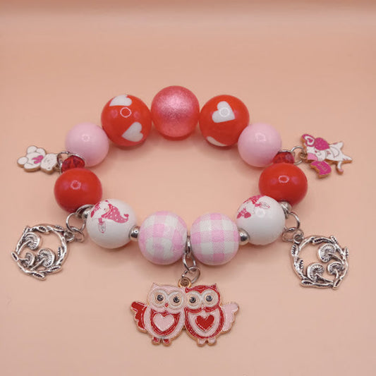 Forest cottagecore charm bracelet stack with red and pink beads featuring owl and heart charms