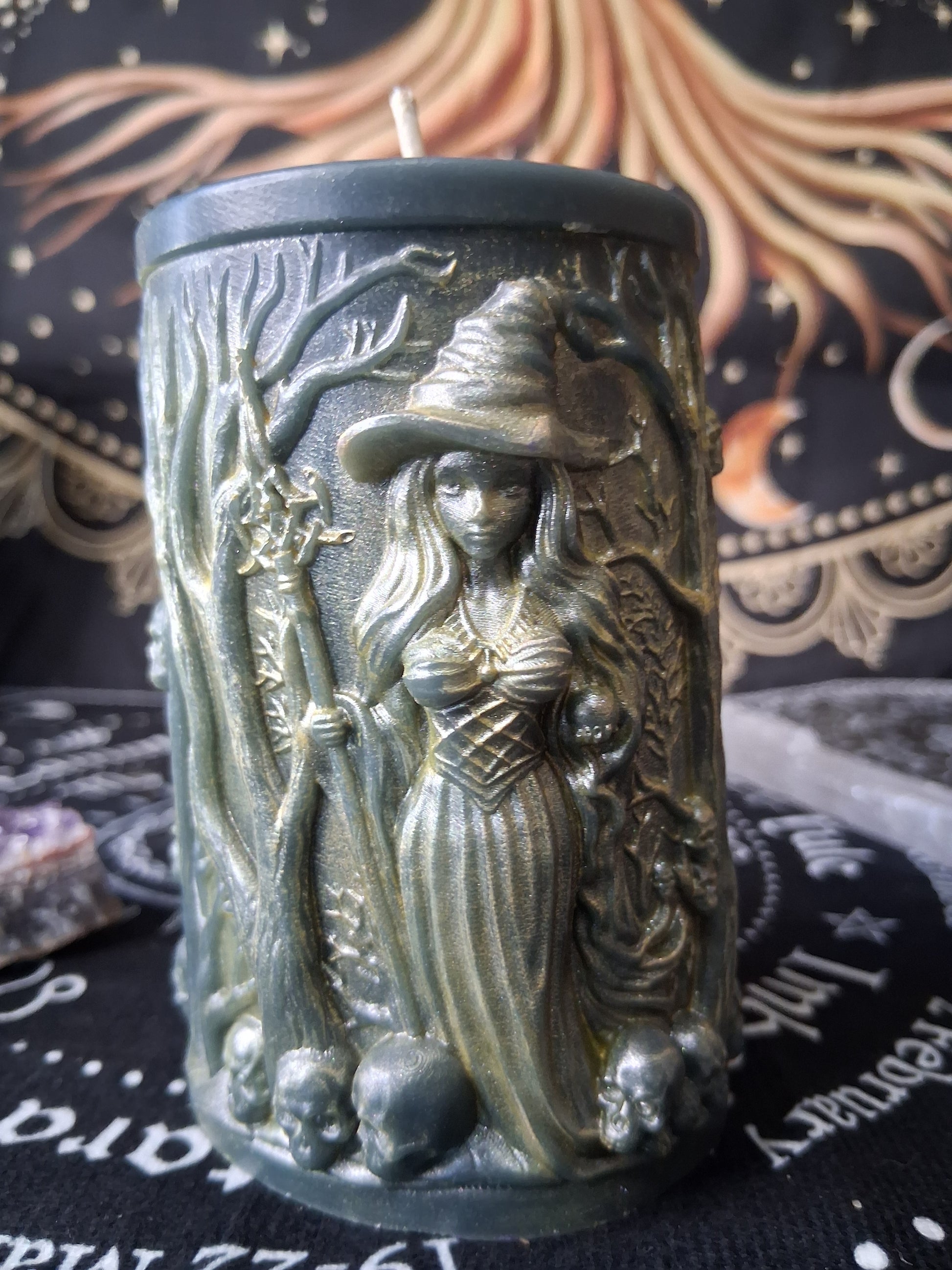 Sacred Moon Candle Co forest witch ritual candle featuring a detailed witch with a staff and skulls design