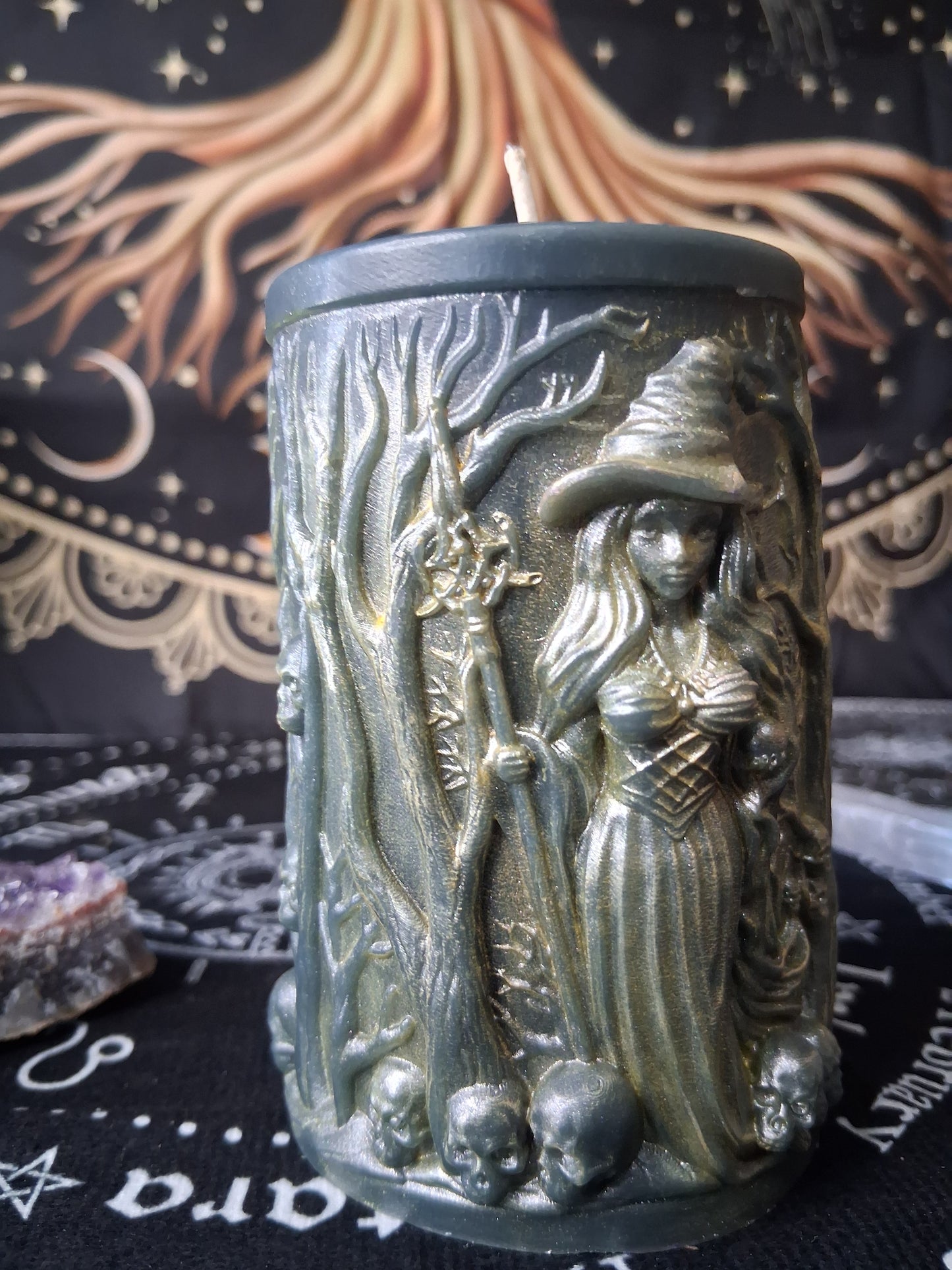 Sacred Moon Candle Co forest witch ritual candle with witch figure and tree designs on green wax