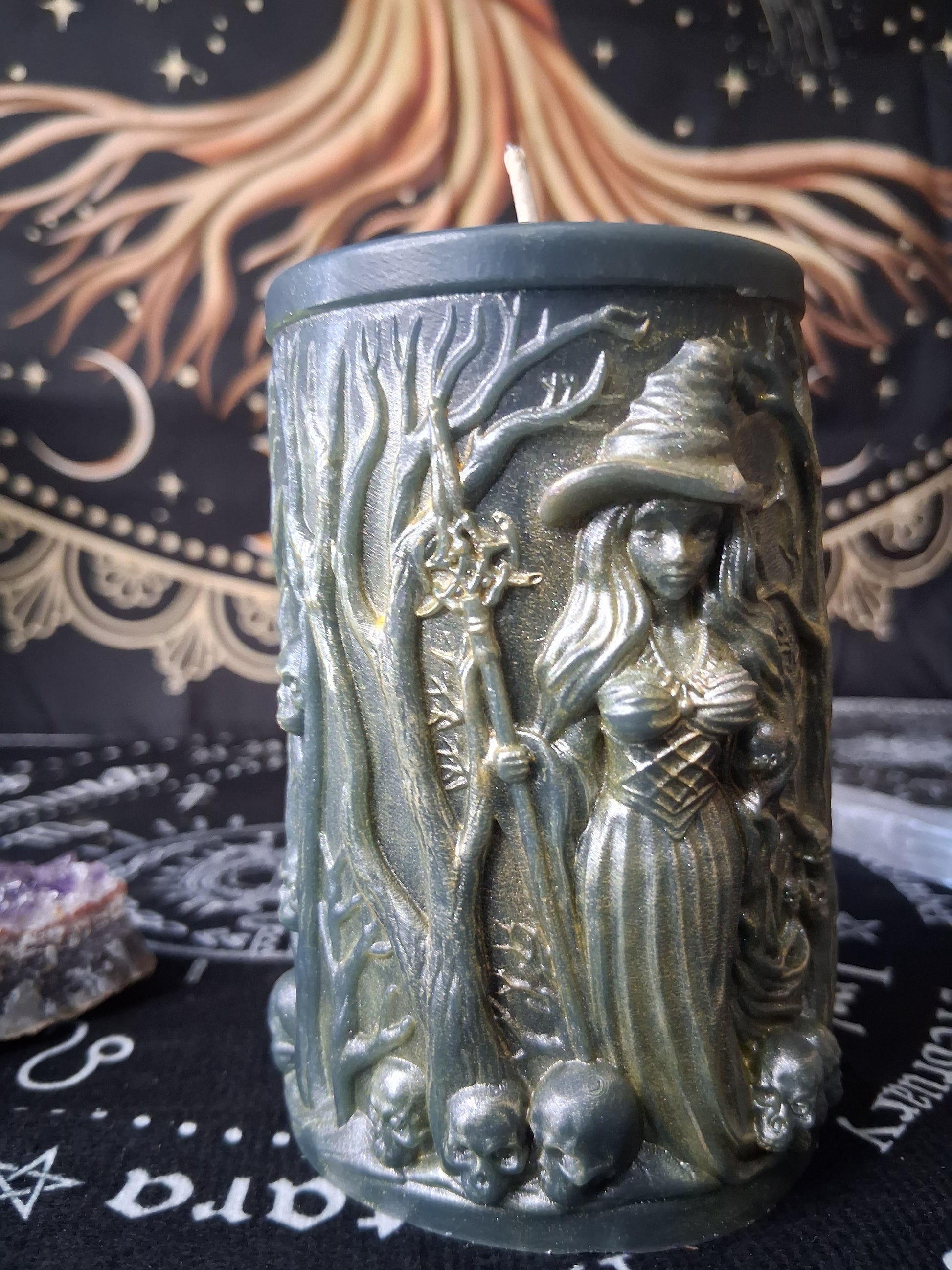 Sacred Moon Candle Co forest witch ritual candle with witch figure and tree designs on green wax