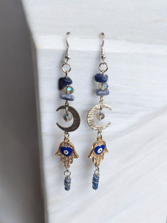 Sacred Moon Candle Co crescent moon hamsa earrings with blue stones and silver charms