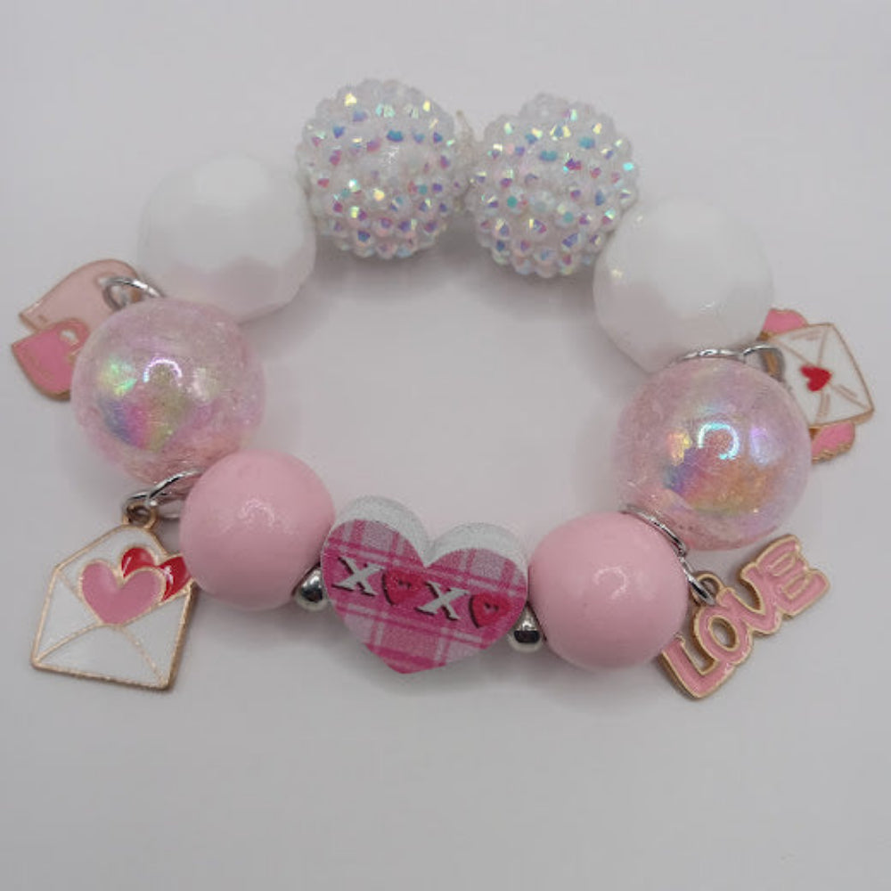 Sacred Moon Candle Co bracelet featuring hugs and kisses heart jewelry charm with pink and white beads