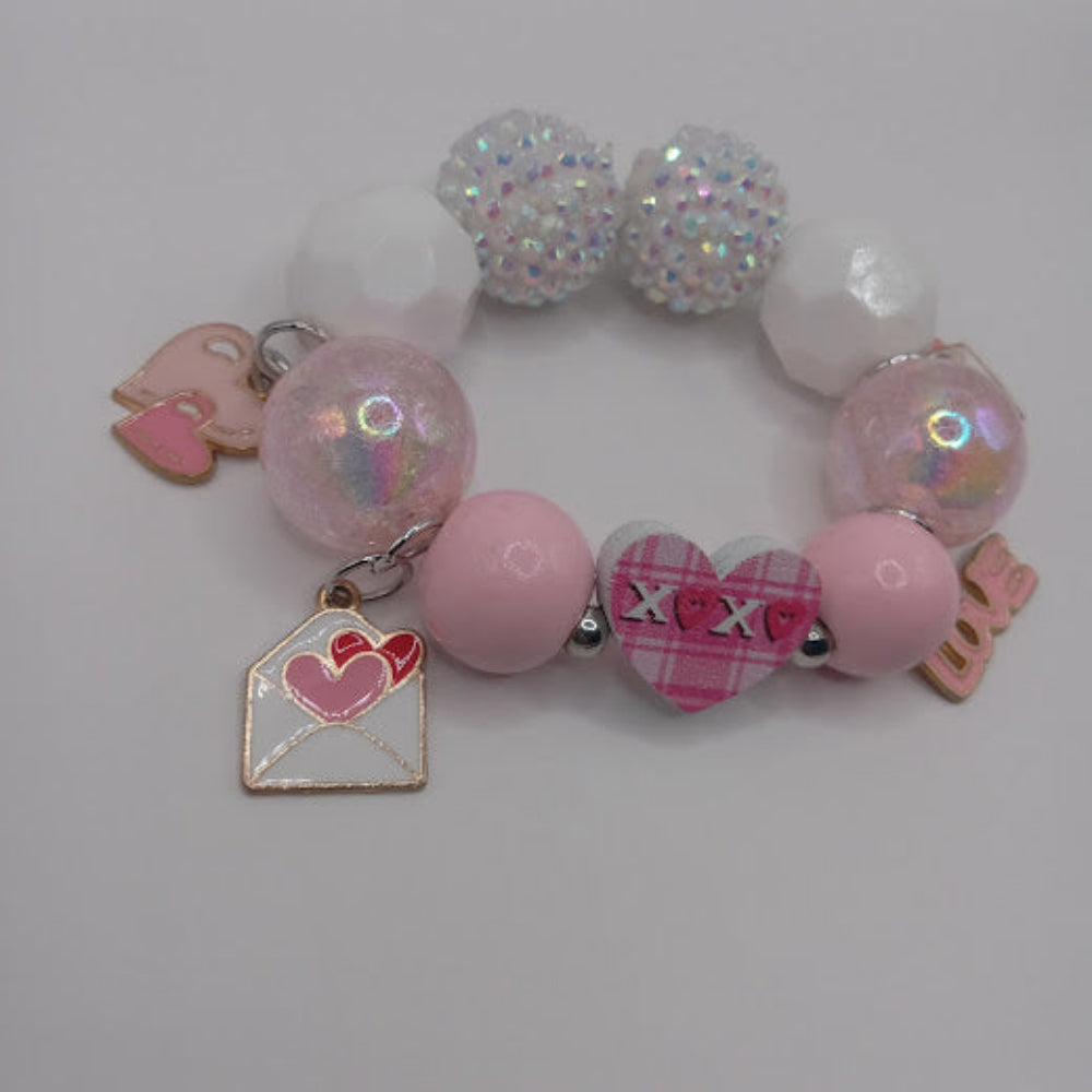 Sacred Moon Candle Co bracelet with hugs and kisses heart jewelry design featuring pink and white beads and heart charms