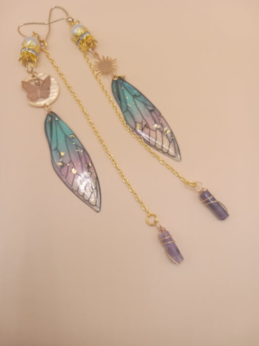 Sacred Moon Candle Co blue and violet fairy earrings with gold filigree fairy wings and amethyst dangle