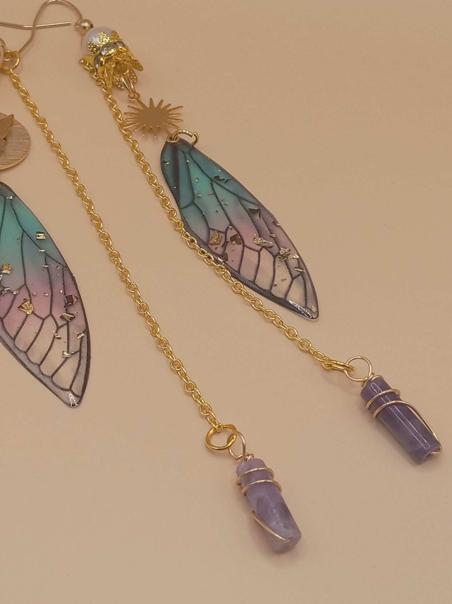 Sacred Moon Candle Co blue and violet fairy earrings with gold chain gradient wing charms and amethyst points