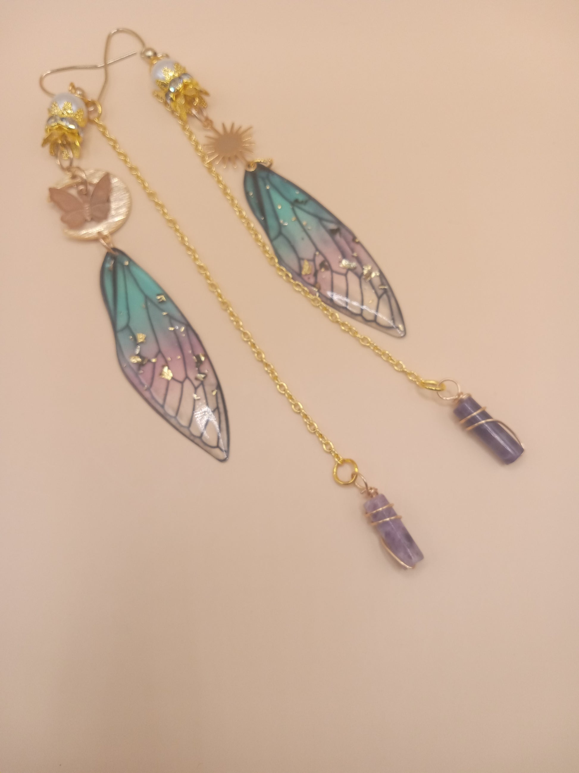 Sacred Moon Candle Co blue and violet fairy earrings with gold chains fairy wing charms and amethyst crystal points