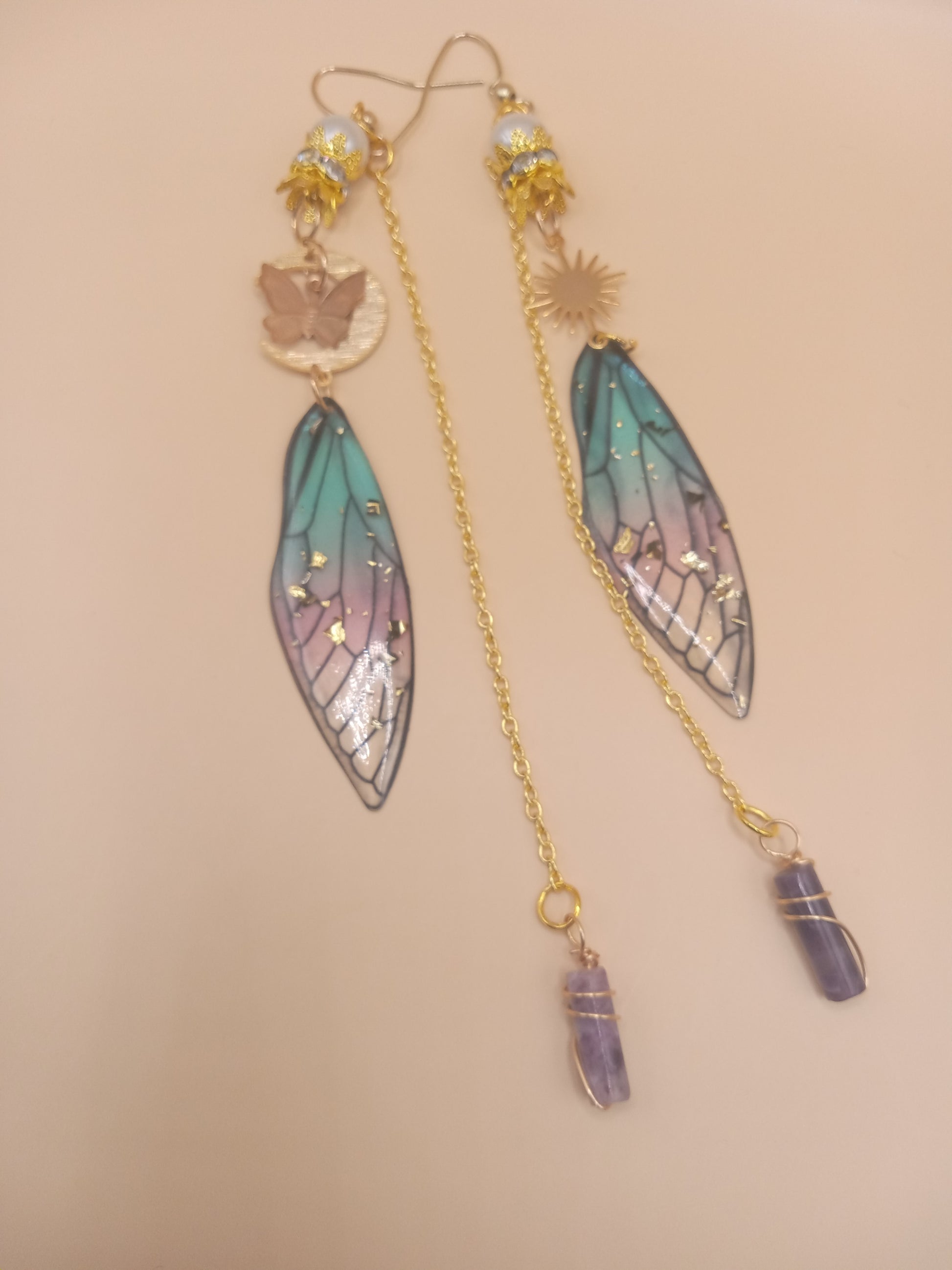 blue and violet fairy earrings from Sacred Moon Candle Co long gold chain dangles with wing charms and amethyst crystal points