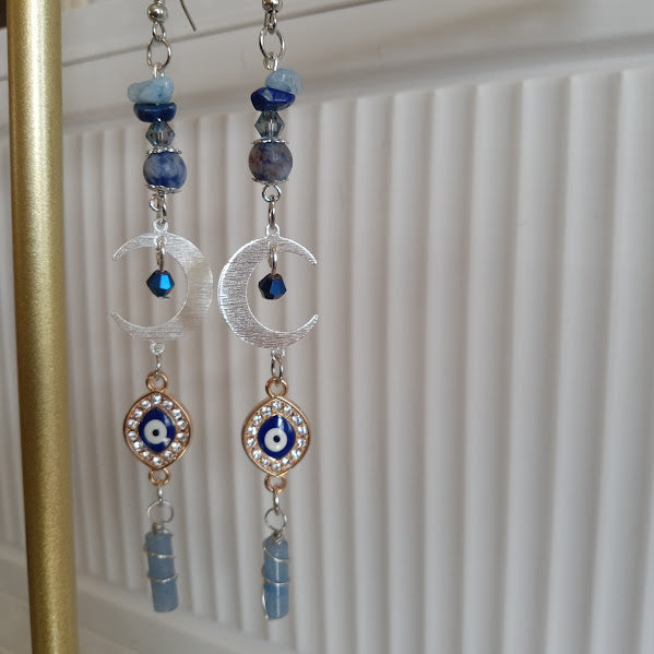 Sacred Moon Candle Co crescent moon evil eye earrings long silver dangle with blue beads and crystal accents