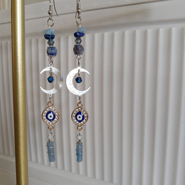 Sacred Moon Candle Co crescent moon evil eye earrings with silver crescents blue beads and dangling charms