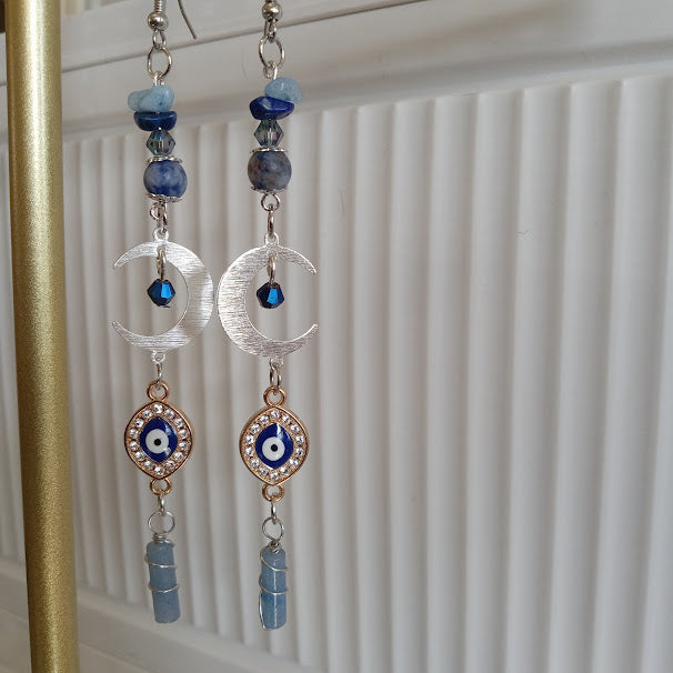 Sacred Moon Candle Co handmade crescent moon evil eye earrings with silver crescents blue beads and dangling light blue stones